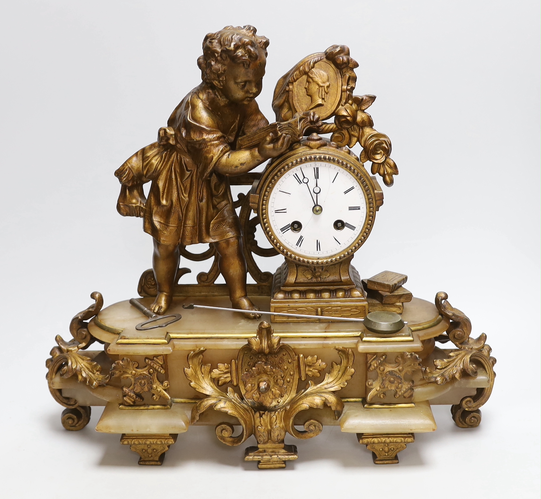 A French bronze and onyx mantel clock by Japy Frere with figure of a child reading, striking on a bell, height 38cm